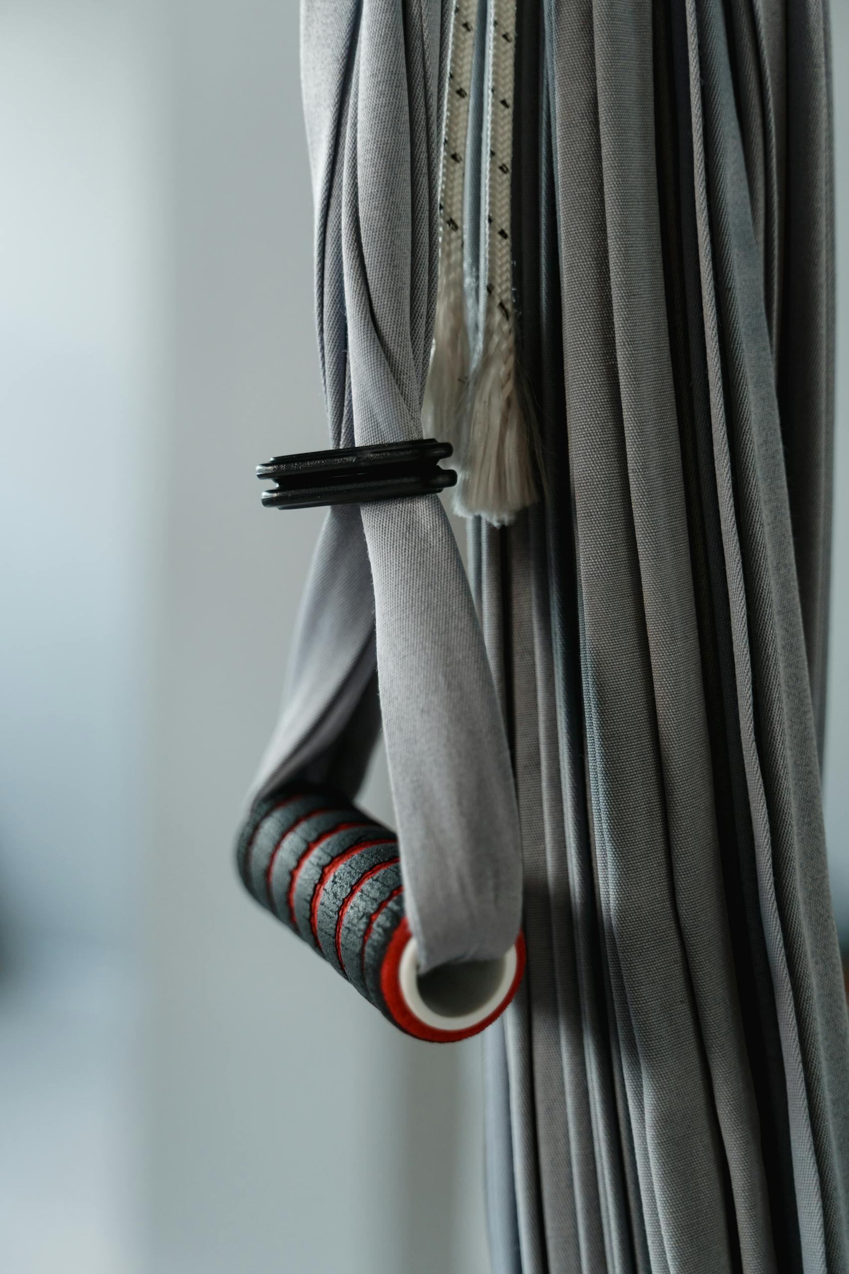 Gray aerial yoga equipment with handlebar, ideal for exercise setups.